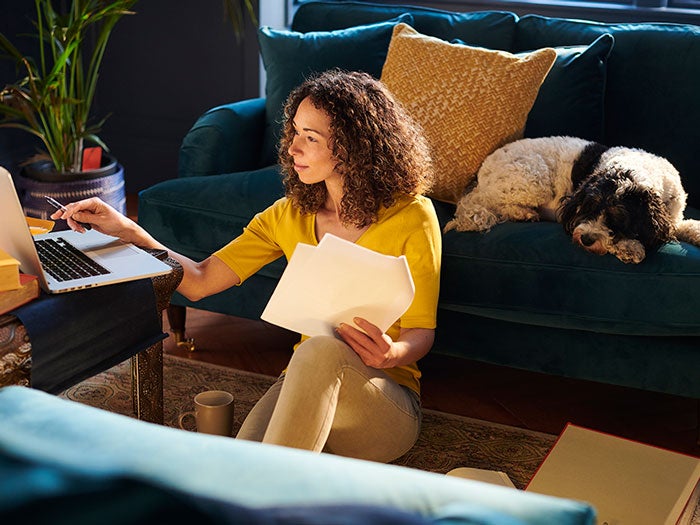 Young woman working late with her dog