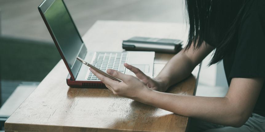 woman with phone and computer