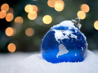 Ornament that looks like the world in a pile of snow